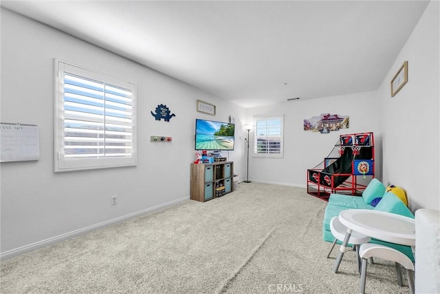 playroom featuring carpet floors and a healthy amount of sunlight