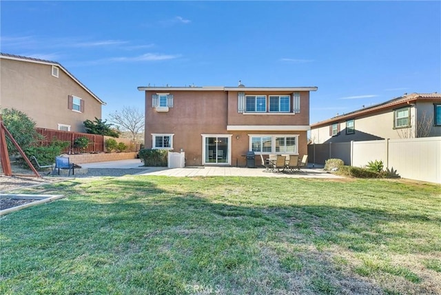 back of house with a patio area and a lawn