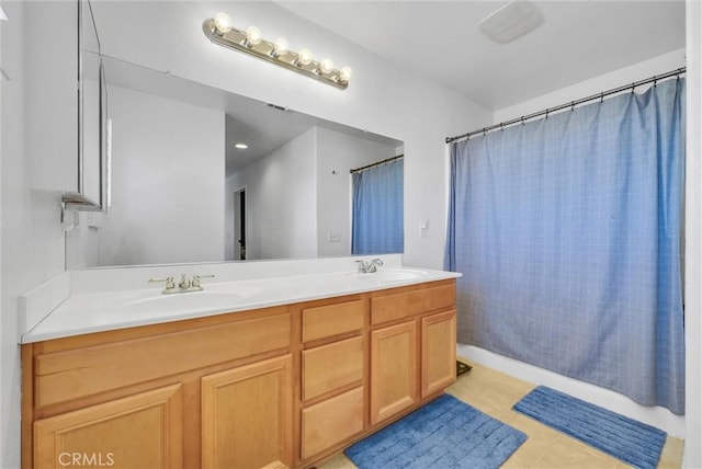 bathroom with tile patterned floors, vanity, and shower / bath combo