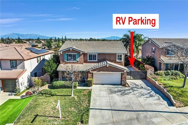 view of front facade featuring a front lawn, a garage, and a mountain view