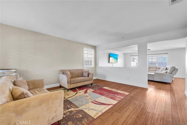 living room featuring hardwood / wood-style flooring and a healthy amount of sunlight