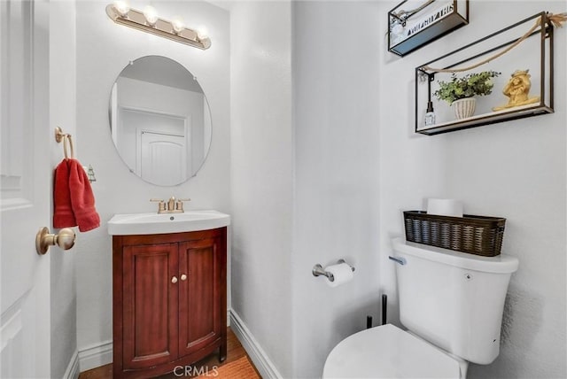 bathroom featuring toilet and vanity