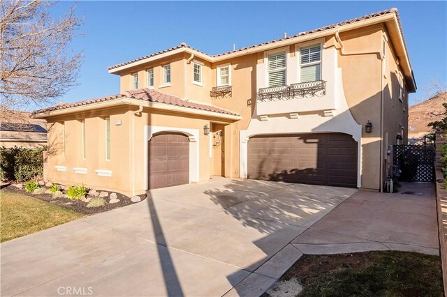 mediterranean / spanish-style home with a garage