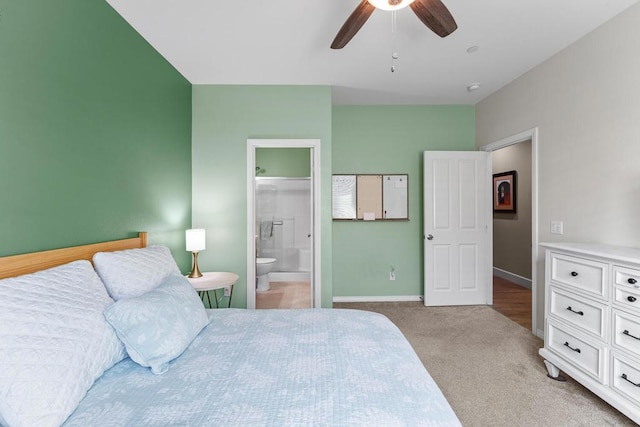 bedroom with light carpet, ceiling fan, and ensuite bathroom