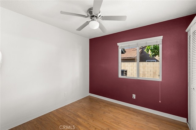 spare room with hardwood / wood-style flooring and ceiling fan