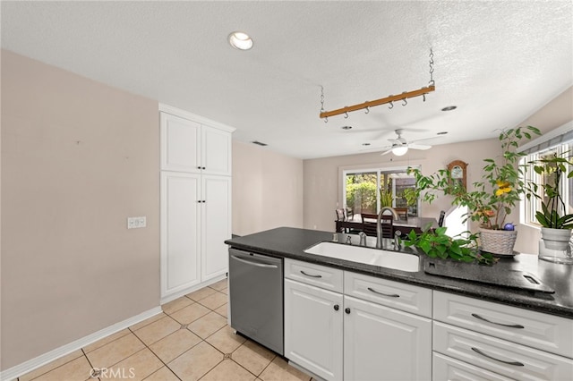 kitchen featuring sink, ceiling fan, dishwasher, white cabinetry, and light tile patterned flooring