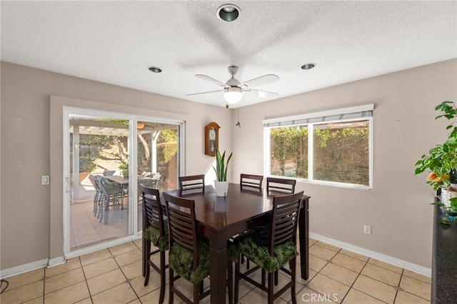 dining room with light tile patterned floors, a textured ceiling, and ceiling fan