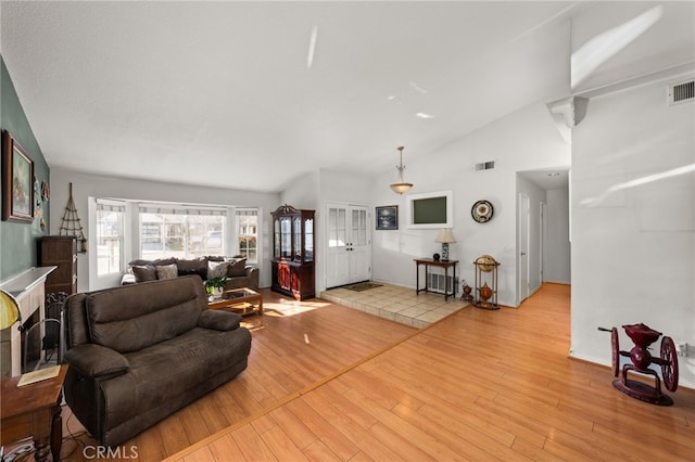 living room featuring light hardwood / wood-style flooring and vaulted ceiling