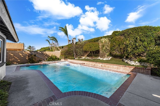 view of swimming pool with a patio and pool water feature