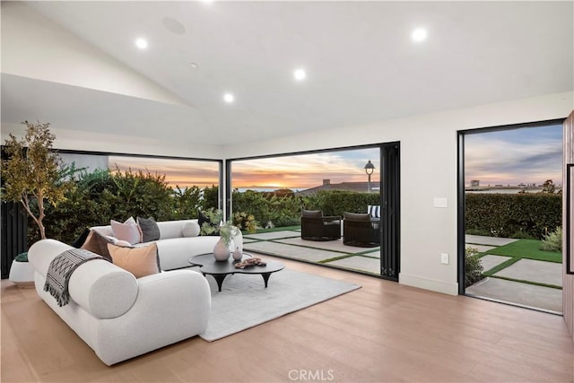 living room featuring high vaulted ceiling, recessed lighting, and wood finished floors