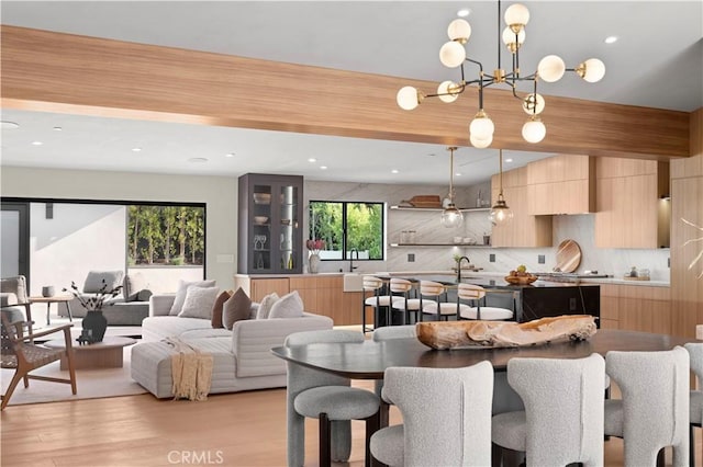 dining space with recessed lighting and light wood-style flooring
