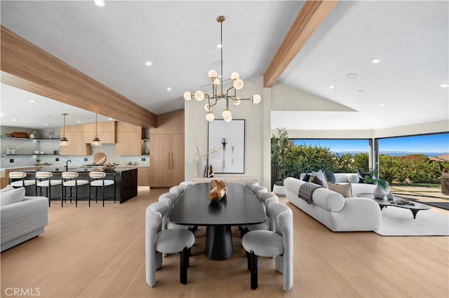 dining room featuring a notable chandelier, lofted ceiling with beams, and light wood-type flooring