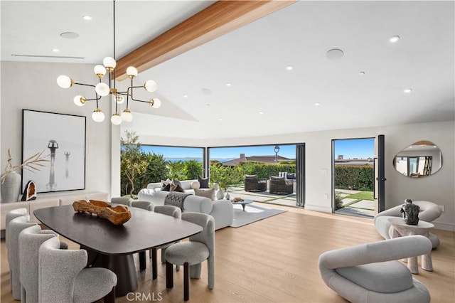 dining room with a notable chandelier, high vaulted ceiling, recessed lighting, wood finished floors, and beamed ceiling