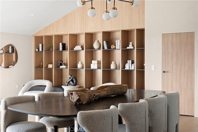 dining room with lofted ceiling and light wood-style floors