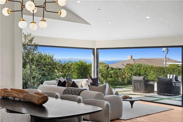 sunroom featuring lofted ceiling, a notable chandelier, and a mountain view