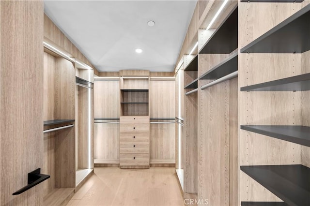 walk in closet featuring light hardwood / wood-style flooring