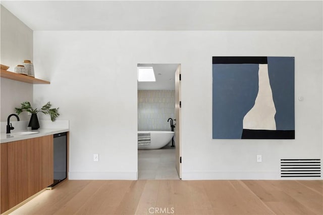 interior space with sink and light wood-type flooring