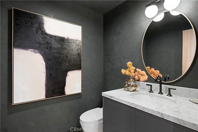 half bath featuring toilet and vanity