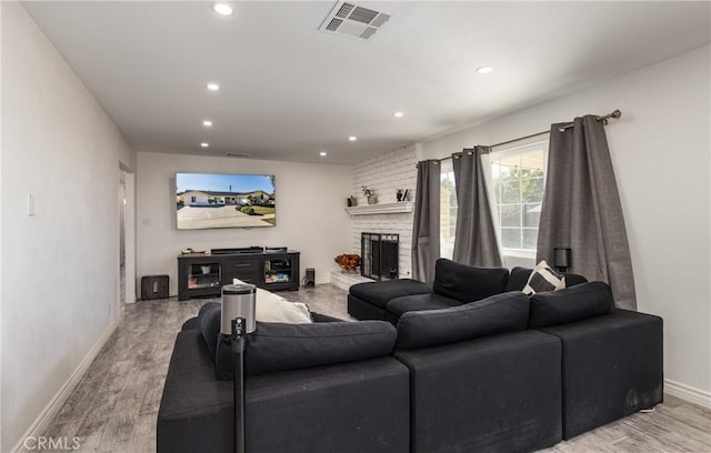 living room featuring a fireplace and light hardwood / wood-style flooring