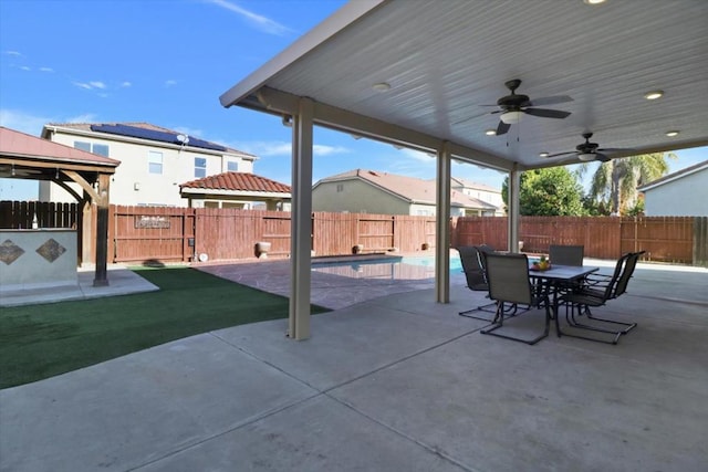 view of patio / terrace featuring a fenced in pool, a gazebo, and ceiling fan