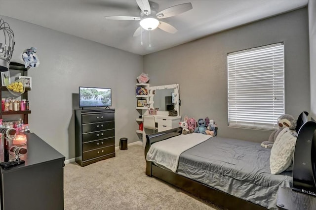 bedroom with multiple windows, ceiling fan, and light carpet