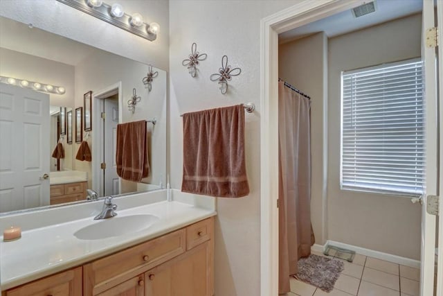 bathroom featuring a shower with shower curtain, vanity, and tile patterned flooring