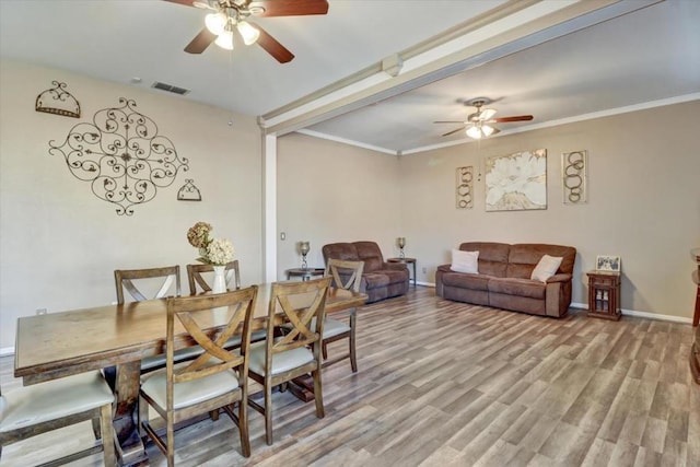 dining space featuring ornamental molding, light hardwood / wood-style floors, and ceiling fan