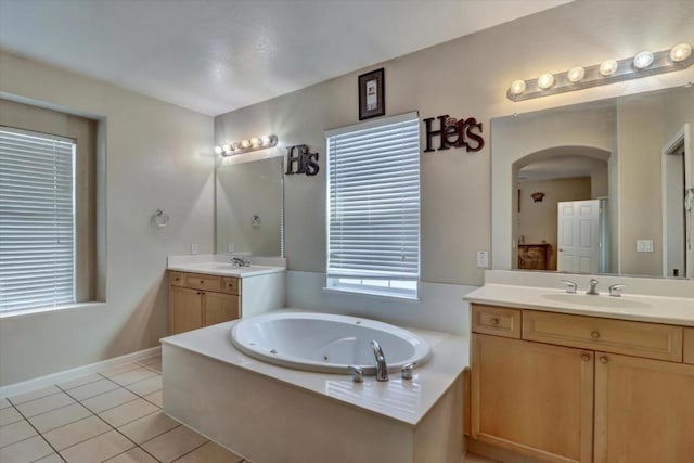 bathroom featuring vanity, a tub to relax in, and tile patterned floors