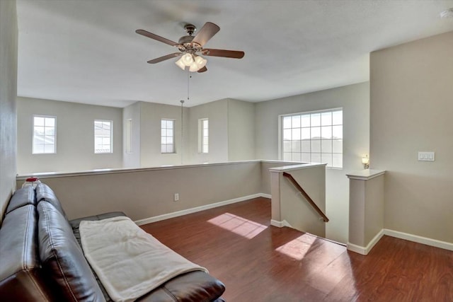 sitting room with dark hardwood / wood-style floors and ceiling fan