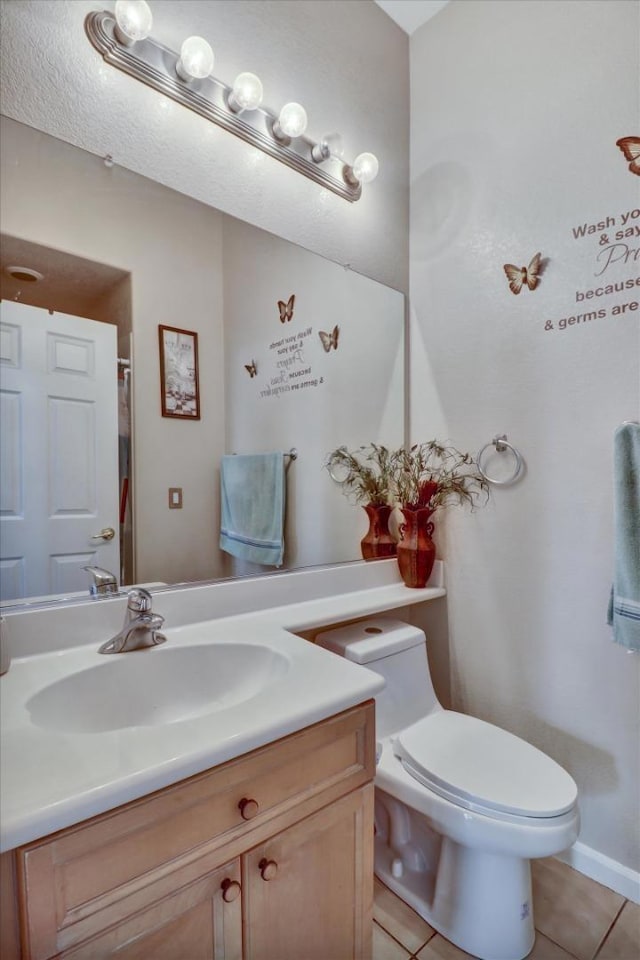 bathroom with vanity, tile patterned floors, and toilet