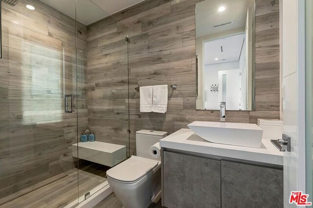 bathroom featuring walk in shower, vanity, and toilet