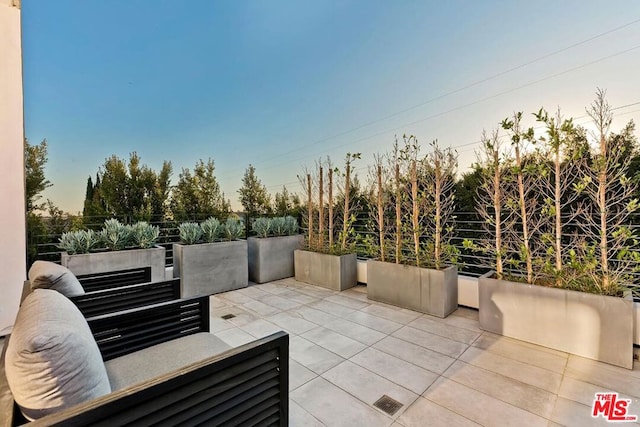 view of patio terrace at dusk