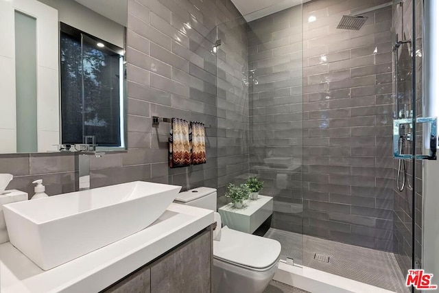 bathroom with vanity, an enclosed shower, tile walls, and toilet