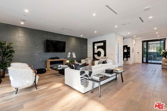 living room with light hardwood / wood-style flooring