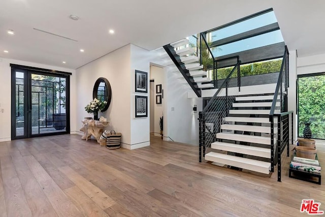 entrance foyer featuring light hardwood / wood-style floors and a wealth of natural light