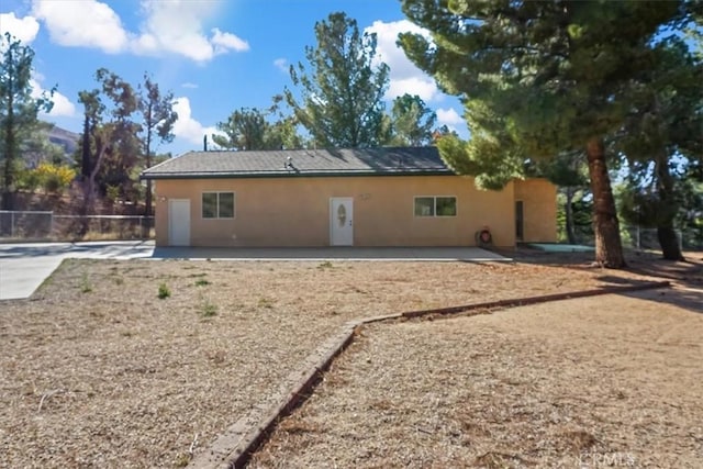 rear view of property featuring a patio area