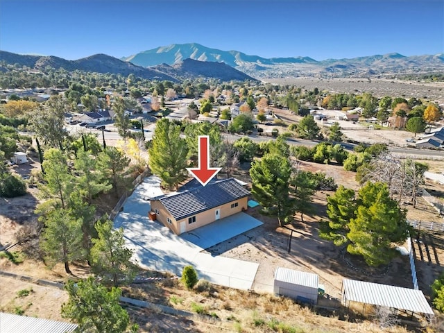 birds eye view of property with a mountain view