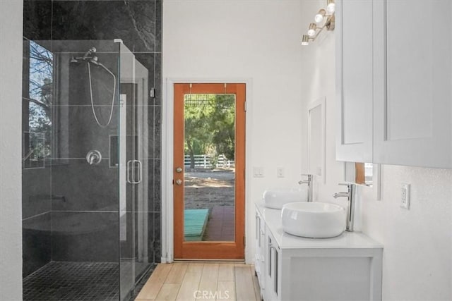 bathroom featuring walk in shower and vanity