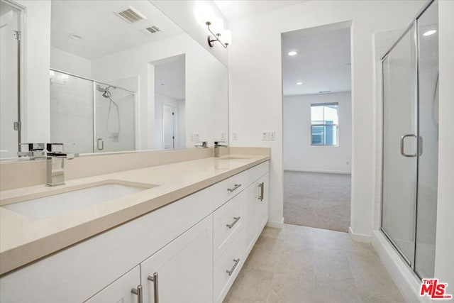 bathroom with walk in shower and vanity