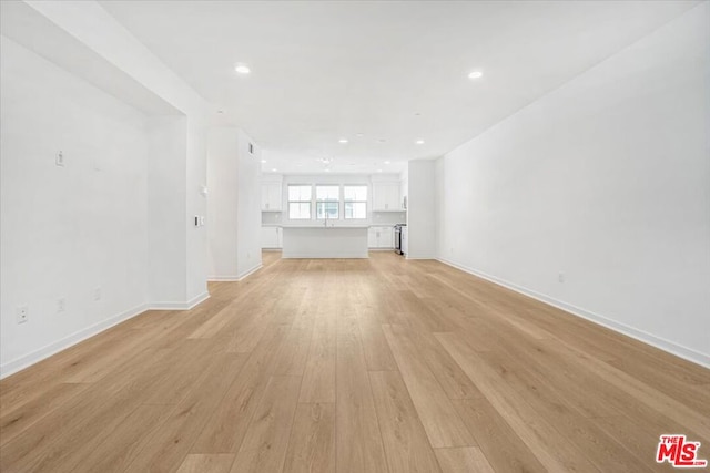 unfurnished living room featuring light wood-type flooring