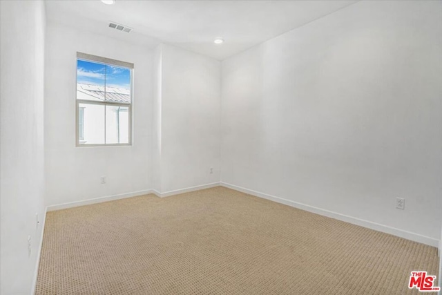 empty room featuring light carpet