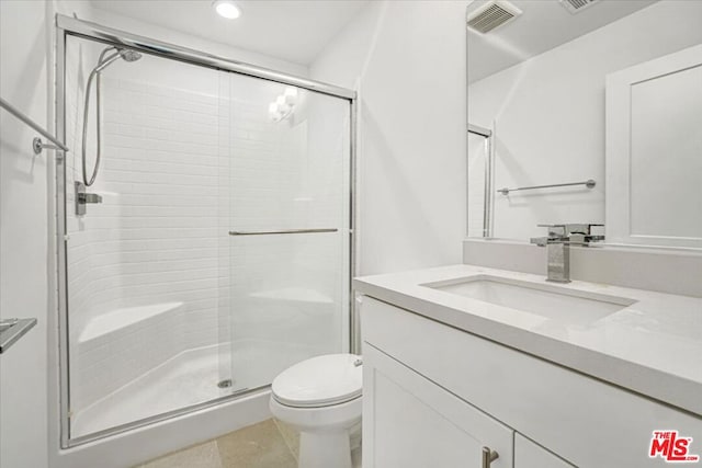 bathroom featuring walk in shower, vanity, and toilet