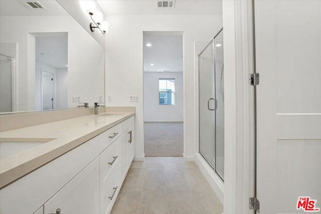 bathroom featuring an enclosed shower and vanity