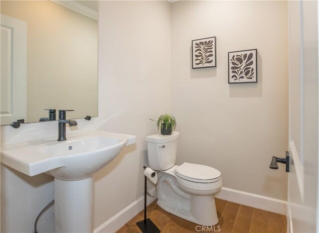 bathroom featuring sink, hardwood / wood-style flooring, and toilet