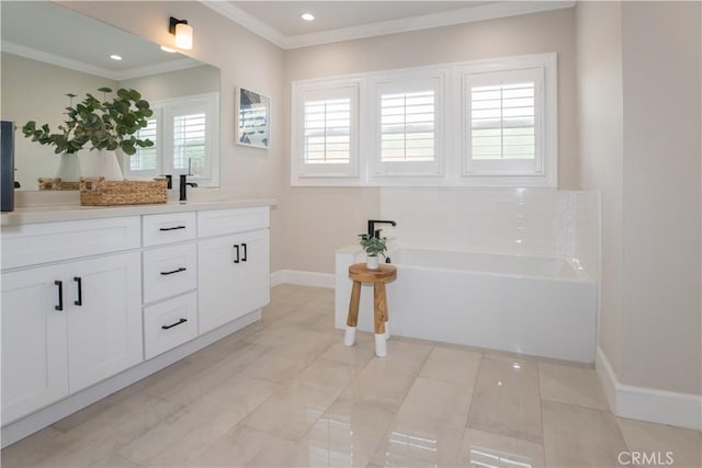 bathroom with ornamental molding, a bathing tub, vanity, and tile patterned floors