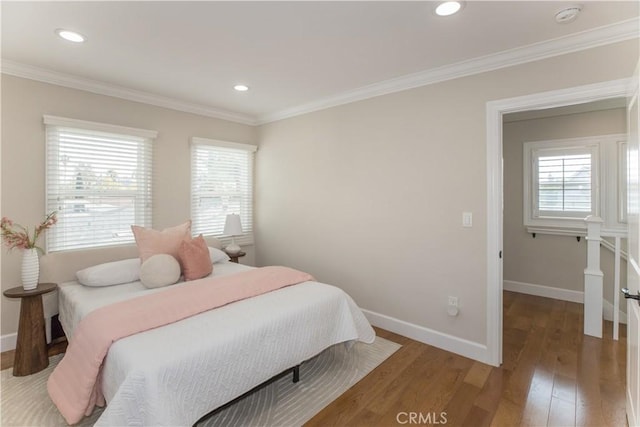 bedroom with crown molding and hardwood / wood-style floors