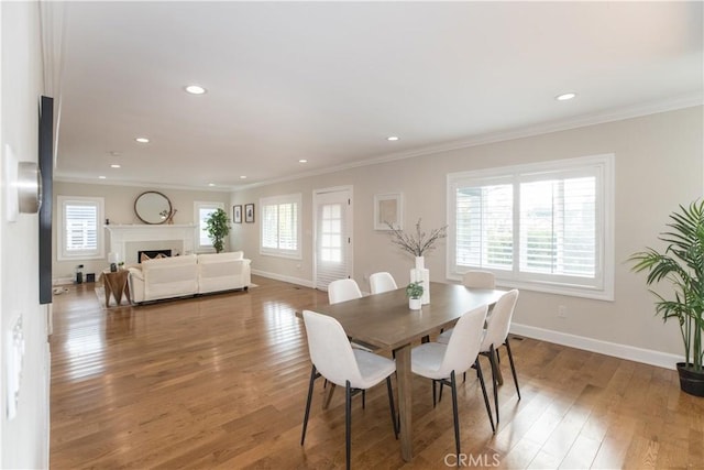 dining space featuring crown molding and hardwood / wood-style floors