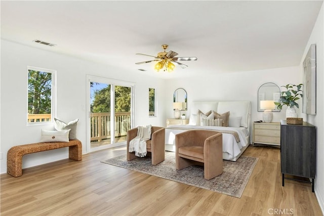 bedroom with access to exterior, light wood-type flooring, and ceiling fan