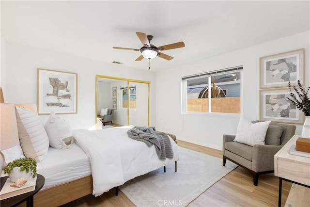 bedroom featuring a closet, ceiling fan, and light hardwood / wood-style floors