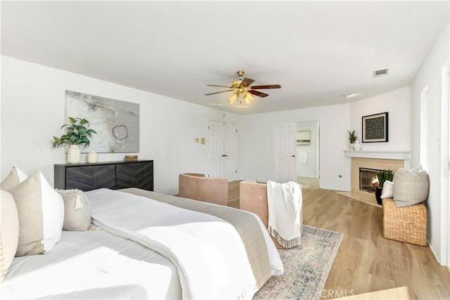 bedroom with ceiling fan and light wood-type flooring